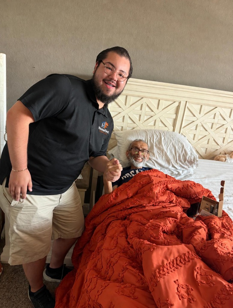 Founder Abraham Cruz holding hands with beloved San Antonio homeowner Mario Moreno after securing a new roof for his family